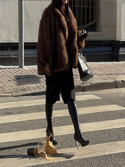 Faux fur coat with polo collar and solid color.